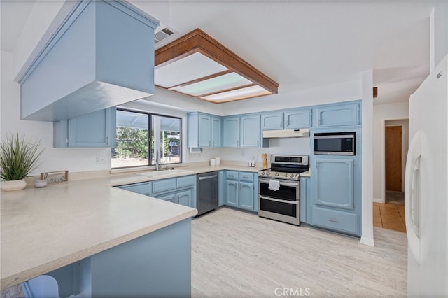 50128 Deer Meadow Way, Oakhurst, CA 93644 - kitchen with stainless steel appliances, blue cabinets, light countertops, light wood-type flooring, and under cabinet range hood