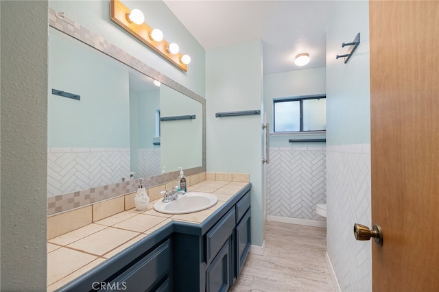 50128 Deer Meadow Way, Oakhurst, CA 93644 - bathroom with vanity, wood finished floors, and a wainscoted wall