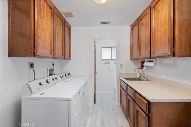 50128 Deer Meadow Way, Oakhurst, CA 93644 - laundry room featuring separate washer and dryer, cabinet space, and light wood finished floors
