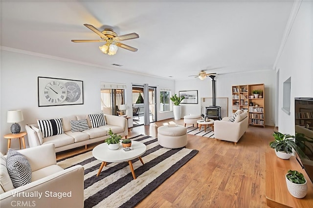 50128 Deer Meadow Way, Oakhurst, CA 93644 - living area with a wood stove, ornamental molding, a ceiling fan, and wood finished floors