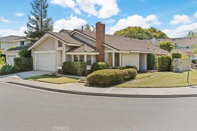 2 Brookstone, Irvine, CA 92604 - view of front of house with a tiled roof, a chimney, an attached garage, driveway, and a front lawn