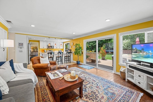 2702 Jacaranda Ave, Carlsbad, CA 92009 - living room featuring ornamental molding, wood finished floors, and recessed lighting