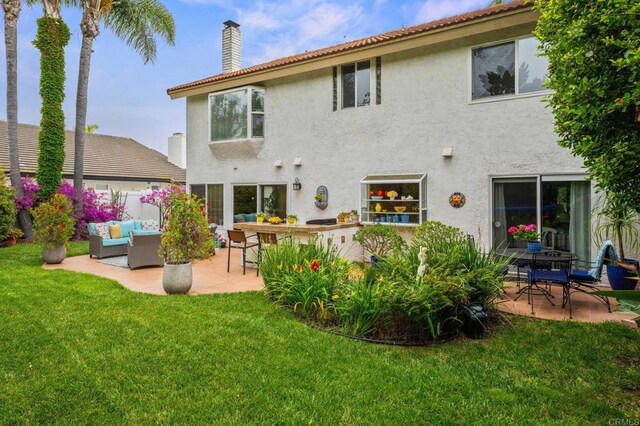 2702 Jacaranda Ave, Carlsbad, CA 92009 - back of property featuring an outdoor living space, a patio, a chimney, and stucco siding