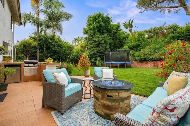 2702 Jacaranda Ave, Carlsbad, CA 92009 - view of patio featuring a trampoline, exterior kitchen, and a fire pit
