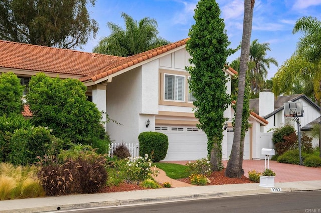 2702 Jacaranda Ave, Carlsbad, CA 92009 - view of front facade featuring a tiled roof, stucco siding, driveway, and a garage
