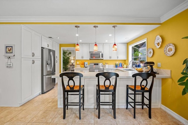 2702 Jacaranda Ave, Carlsbad, CA 92009 - kitchen featuring stainless steel appliances, a peninsula, white cabinetry, light countertops, and pendant lighting