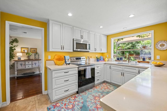 2702 Jacaranda Ave, Carlsbad, CA 92009 - kitchen with stainless steel appliances, white cabinets, light countertops, and recessed lighting