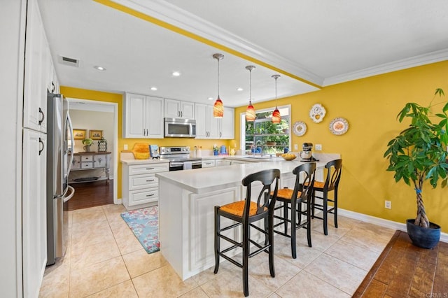 2702 Jacaranda Ave, Carlsbad, CA 92009 - kitchen with appliances with stainless steel finishes, a peninsula, crown molding, a breakfast bar, and light countertops