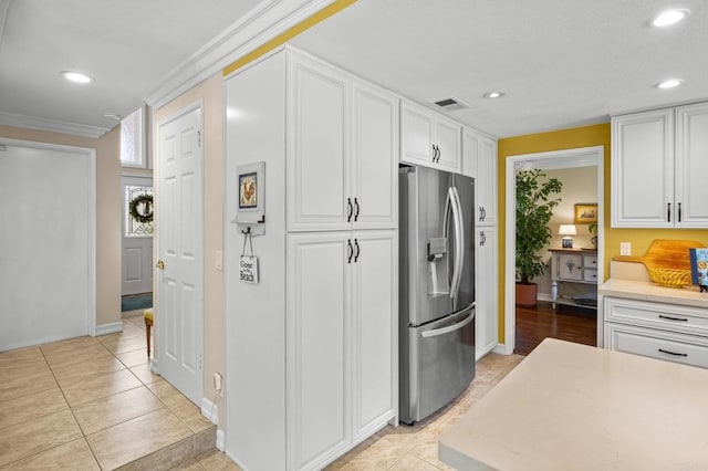 2702 Jacaranda Ave, Carlsbad, CA 92009 - kitchen with stainless steel fridge, light countertops, white cabinets, recessed lighting, and crown molding