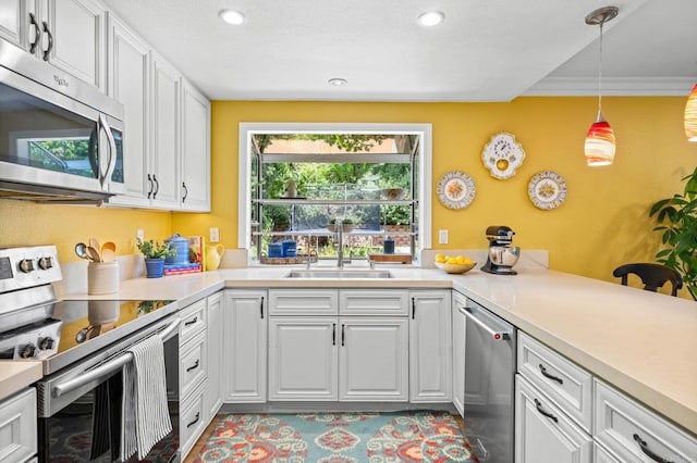 2702 Jacaranda Ave, Carlsbad, CA 92009 - kitchen with appliances with stainless steel finishes, healthy amount of natural light, white cabinets, decorative light fixtures, and recessed lighting