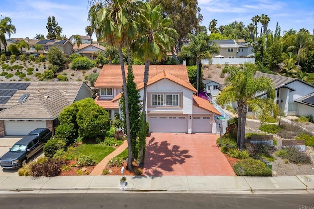 2702 Jacaranda Ave, Carlsbad, CA 92009 - view of front of house with driveway, a residential view, a tile roof, and stucco siding