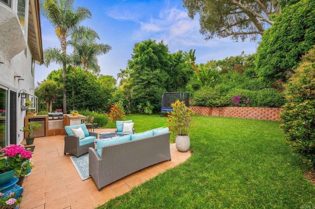 2702 Jacaranda Ave, Carlsbad, CA 92009 - view of green lawn featuring a trampoline, an outdoor kitchen, a patio area, and an outdoor living space