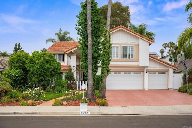 2702 Jacaranda Ave, Carlsbad, CA 92009 - view of front facade with a tiled roof, concrete driveway, stucco siding, and an attached garage