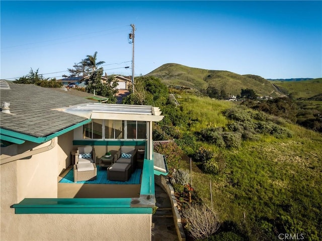 1939 Circle Dr, Cayucos, CA 93430 - back of house with stucco siding, a sunroom, a mountain view, roof with shingles, and outdoor lounge area