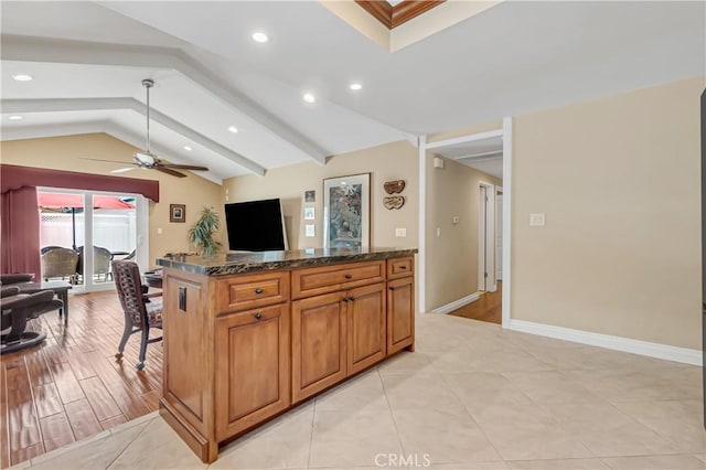 20002 Tomlee Ave, Torrance, CA 90503 - kitchen featuring a ceiling fan, lofted ceiling, recessed lighting, brown cabinetry, and dark stone counters