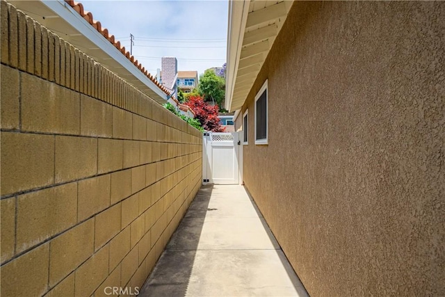 20002 Tomlee Ave, Torrance, CA 90503 - view of side of home with stucco siding and a gate