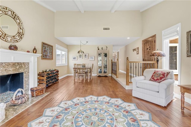 20002 Tomlee Ave, Torrance, CA 90503 - living area featuring a heating unit, light wood-type flooring, high vaulted ceiling, beamed ceiling, and a premium fireplace