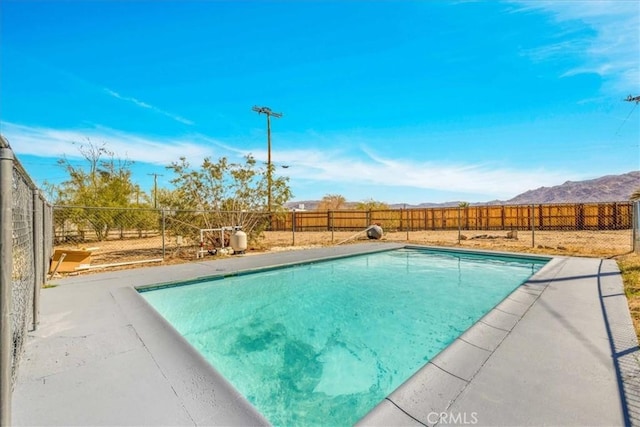 73461 El Paseo Dr Unit 29, Palms, CA 92277 - view of swimming pool featuring a fenced backyard, a mountain view, and a patio