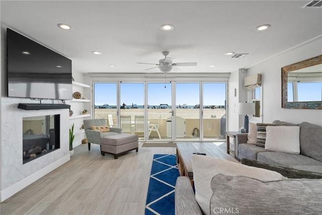 3312 W Oceanfront, Newport Beach, CA 92663 - living room featuring a high end fireplace, a ceiling fan, wood finished floors, and recessed lighting