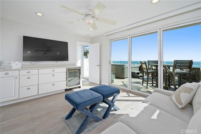 3312 W Oceanfront, Newport Beach, CA 92663 - living area featuring beverage cooler, light wood-style flooring, recessed lighting, a ceiling fan, and a water view