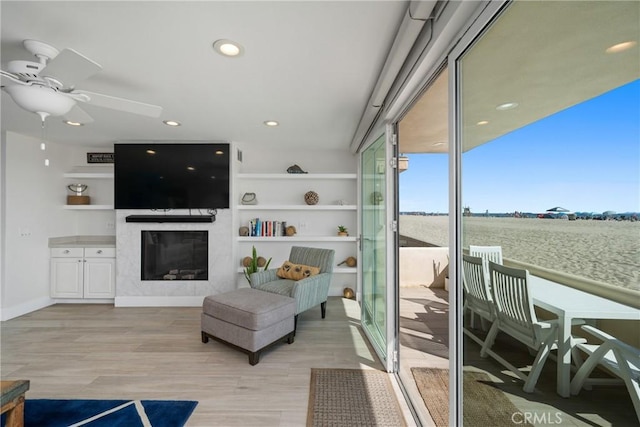 3312 W Oceanfront, Newport Beach, CA 92663 - living room featuring a premium fireplace, light wood-type flooring, a ceiling fan, and recessed lighting