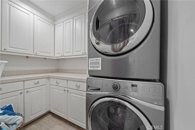 3312 W Oceanfront, Newport Beach, CA 92663 - washroom with cabinet space, stacked washer / drying machine, and light wood-style flooring