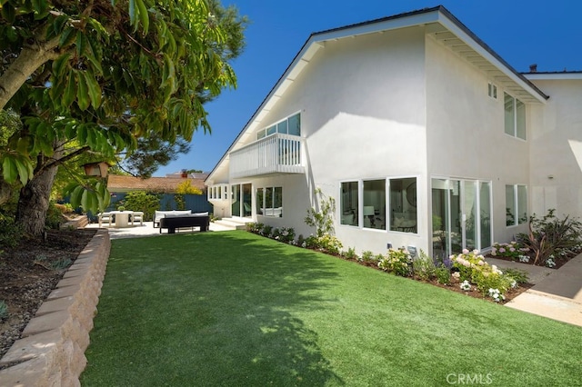 1933 Port Bristol Cir, Newport Beach, CA 92660 - rear view of house featuring an outdoor living space, a balcony, stucco siding, a yard, and a patio