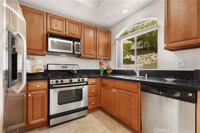 30902 Clubhouse Dr Unit 17A, Laguna Niguel, CA 92677 - kitchen featuring appliances with stainless steel finishes, dark countertops, and brown cabinets