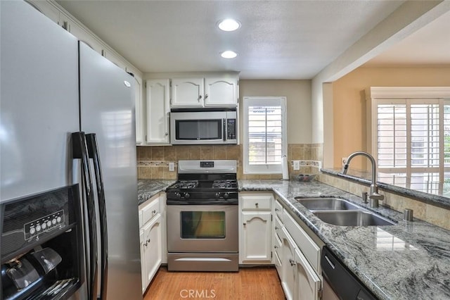 8366 Gabriel Dr Unit D, Rancho Cucamonga, CA 91730 - kitchen featuring appliances with stainless steel finishes, white cabinets, light stone countertops, light wood-style floors, and recessed lighting