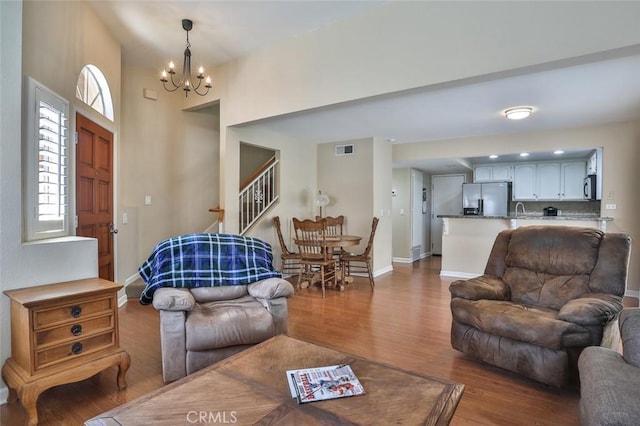 8366 Gabriel Dr Unit D, Rancho Cucamonga, CA 91730 - living room featuring wood finished floors, a chandelier, and stairway