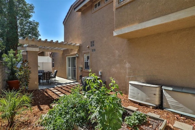 8366 Gabriel Dr Unit D, Rancho Cucamonga, CA 91730 - rear view of property with a pergola, a patio area, and stucco siding