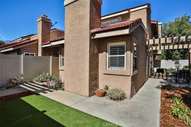 8366 Gabriel Dr Unit D, Rancho Cucamonga, CA 91730 - back of house featuring a patio, stucco siding, and a chimney