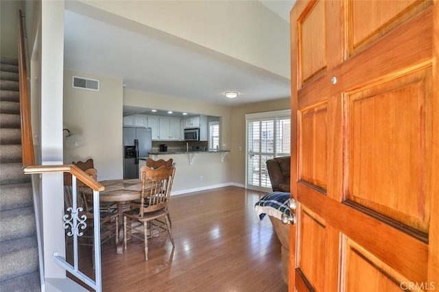 8366 Gabriel Dr Unit D, Rancho Cucamonga, CA 91730 - dining space featuring stairway and dark wood-style flooring