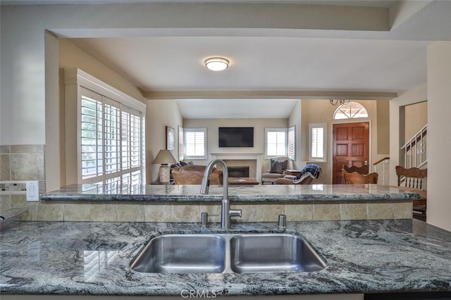 8366 Gabriel Dr Unit D, Rancho Cucamonga, CA 91730 - kitchen featuring stone countertops, a fireplace, and open floor plan