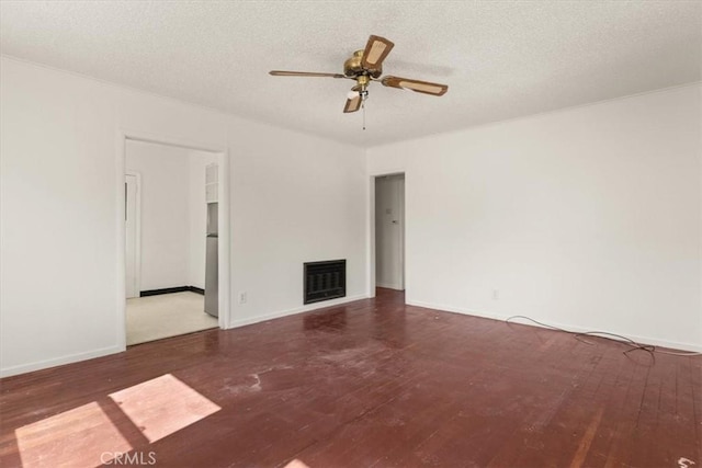 1550 Kaufman Ave, Corning, CA 96021 - unfurnished living room featuring hardwood / wood-style floors, a fireplace, a ceiling fan, and a textured ceiling