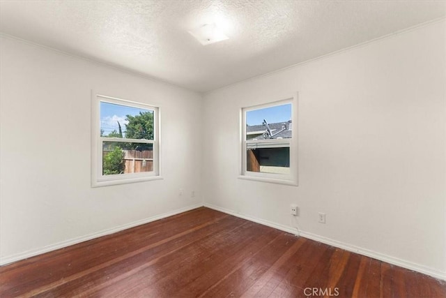1550 Kaufman Ave, Corning, CA 96021 - spare room featuring dark wood finished floors and a textured ceiling