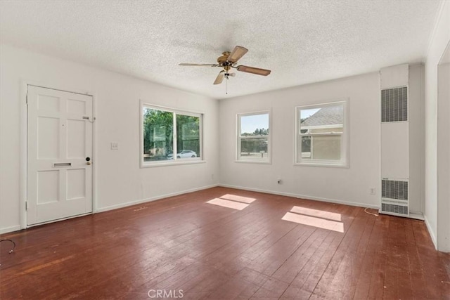 1550 Kaufman Ave, Corning, CA 96021 - unfurnished room featuring a heating unit, hardwood / wood-style flooring, a ceiling fan, and a textured ceiling