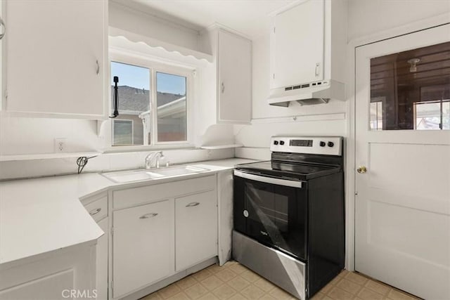1550 Kaufman Ave, Corning, CA 96021 - kitchen featuring stainless steel range with electric stovetop, under cabinet range hood, white cabinets, light countertops, and light flooring