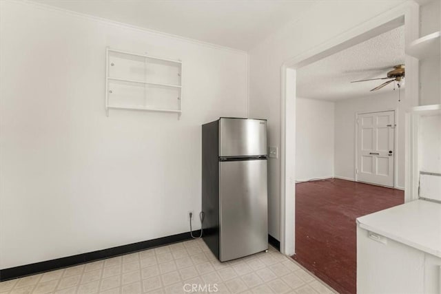 1550 Kaufman Ave, Corning, CA 96021 - kitchen with freestanding refrigerator, ceiling fan, light floors, a textured ceiling, and light countertops