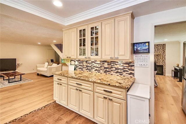 5574 Elsinore Ave, Buena Park, CA 90621 - kitchen with cream cabinets, ornamental molding, decorative backsplash, light wood-style flooring, and recessed lighting