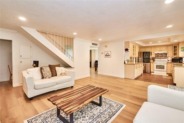5574 Elsinore Ave, Buena Park, CA 90621 - living area with ornamental molding, stairway, recessed lighting, and light wood finished floors