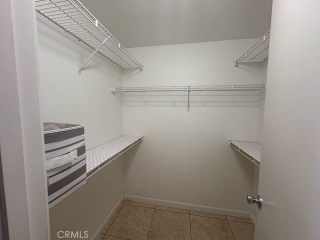 10810 Euclid St, Adelanto, CA 92301 - spacious closet featuring light tile patterned floors