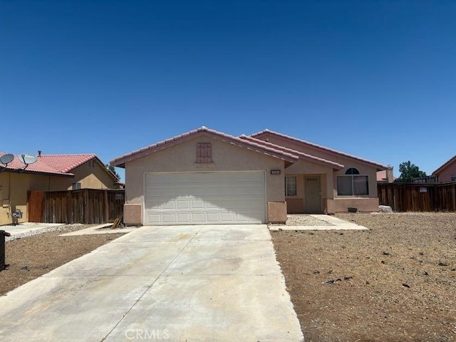 10810 Euclid St, Adelanto, CA 92301 - single story home with concrete driveway, stucco siding, and a garage