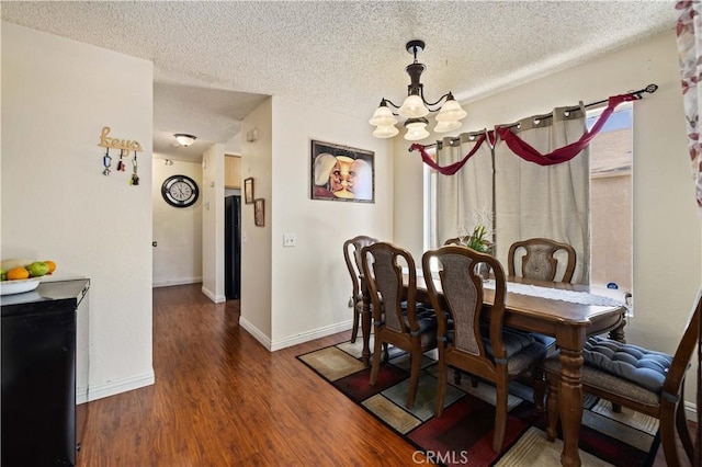 37158 29th St E, Palmdale, CA 93550 - dining area featuring a chandelier, a textured ceiling, and wood finished floors