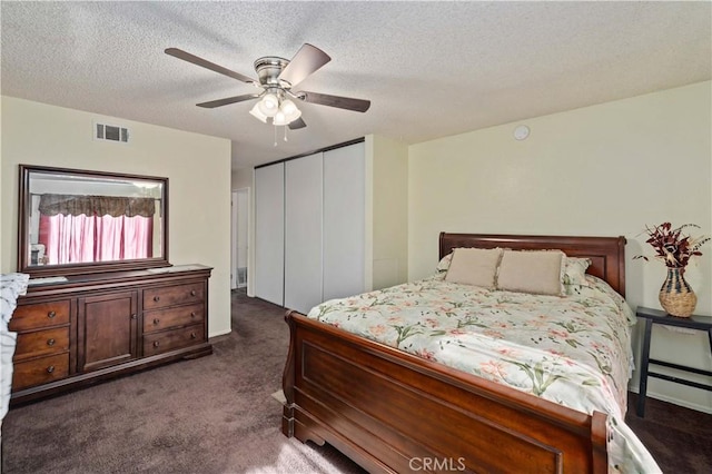 37158 29th St E, Palmdale, CA 93550 - bedroom featuring dark colored carpet, a closet, a ceiling fan, and a textured ceiling