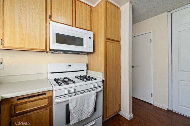37158 29th St E, Palmdale, CA 93550 - kitchen with white appliances, dark wood-style flooring, and light countertops