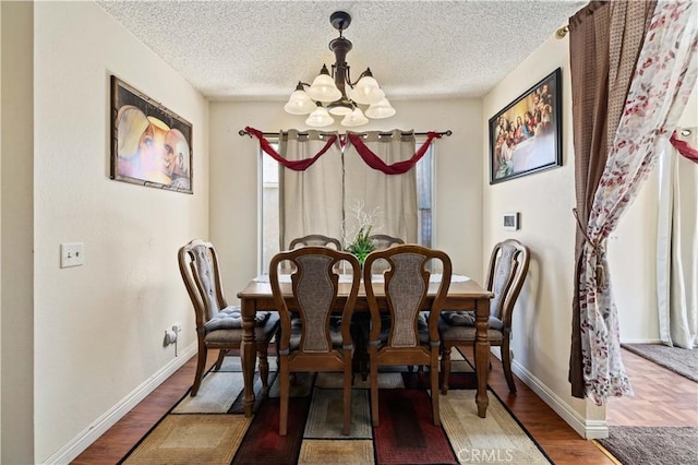 37158 29th St E, Palmdale, CA 93550 - dining room featuring a chandelier, wood finished floors, and a textured ceiling