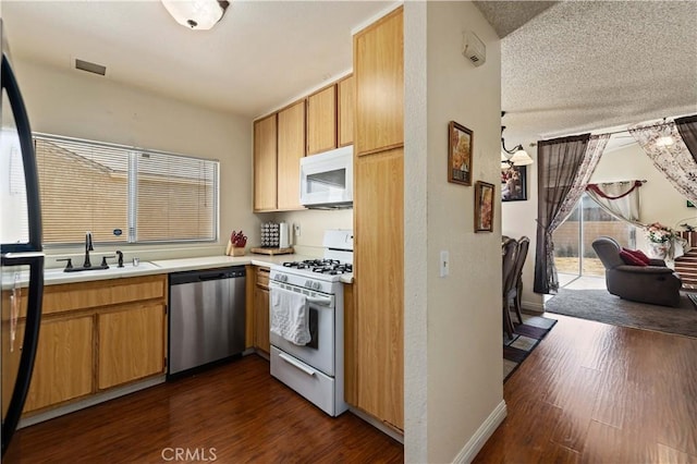 37158 29th St E, Palmdale, CA 93550 - kitchen featuring white appliances, dark wood finished floors, light countertops, and a textured ceiling