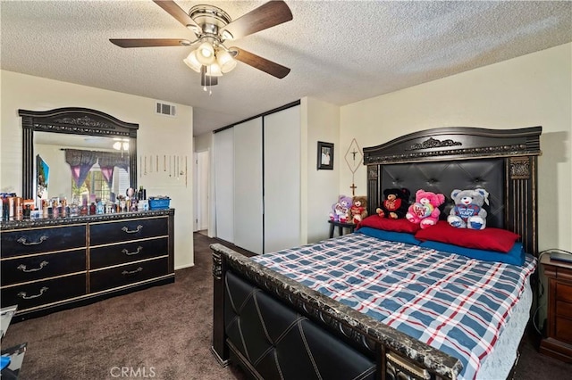 37158 29th St E, Palmdale, CA 93550 - bedroom with dark colored carpet, a closet, a textured ceiling, and ceiling fan