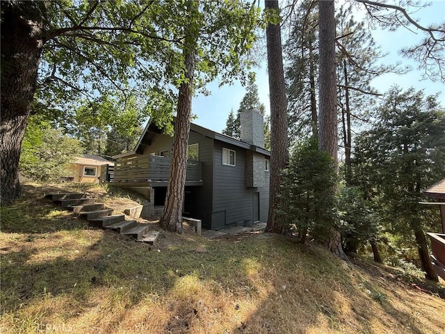 1016 Berne Dr, Crestline, CA 92325 - rear view of property with a chimney and stairs